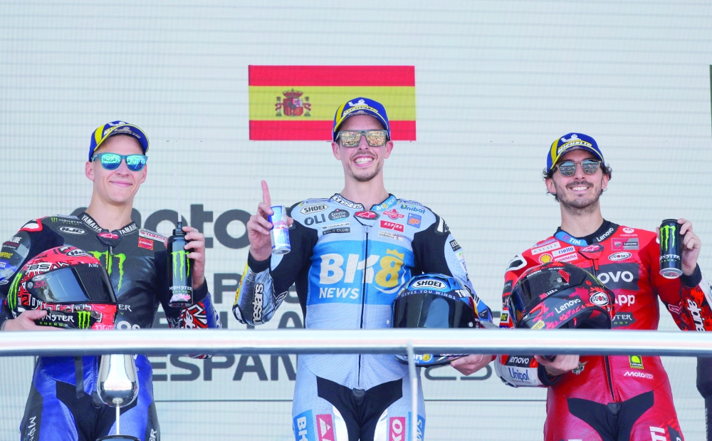 MotoGP's Alex Marquez celebrates on the podium after winning the race with second placed Monster Energy Yamaha MotoGP's Fabio Quartararo and third placed Ducati Lenovo Team's Francesco Bagnaia. — Reuters