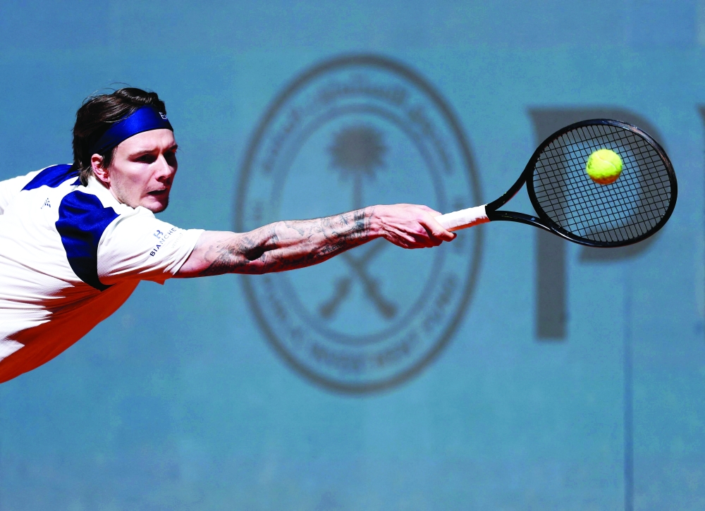 Kazakstan's Alexander Bublik plays a return against Russia's Andrey Rublev during their 2025 ATP Tour Madrid Open tennis tournament third round singles match at the Caja Magica in Madrid, on April 27, 2025.  (Photo by Thomas COEX / AFP)