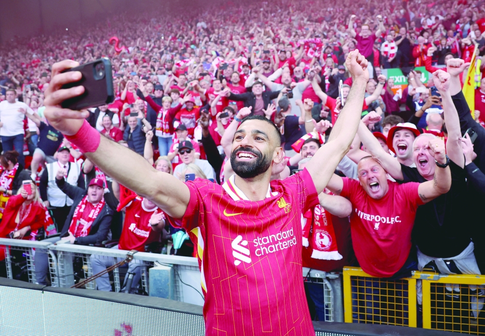 Mohamed Salah takes a selfie with fans after winning the Premier League. — Reuters