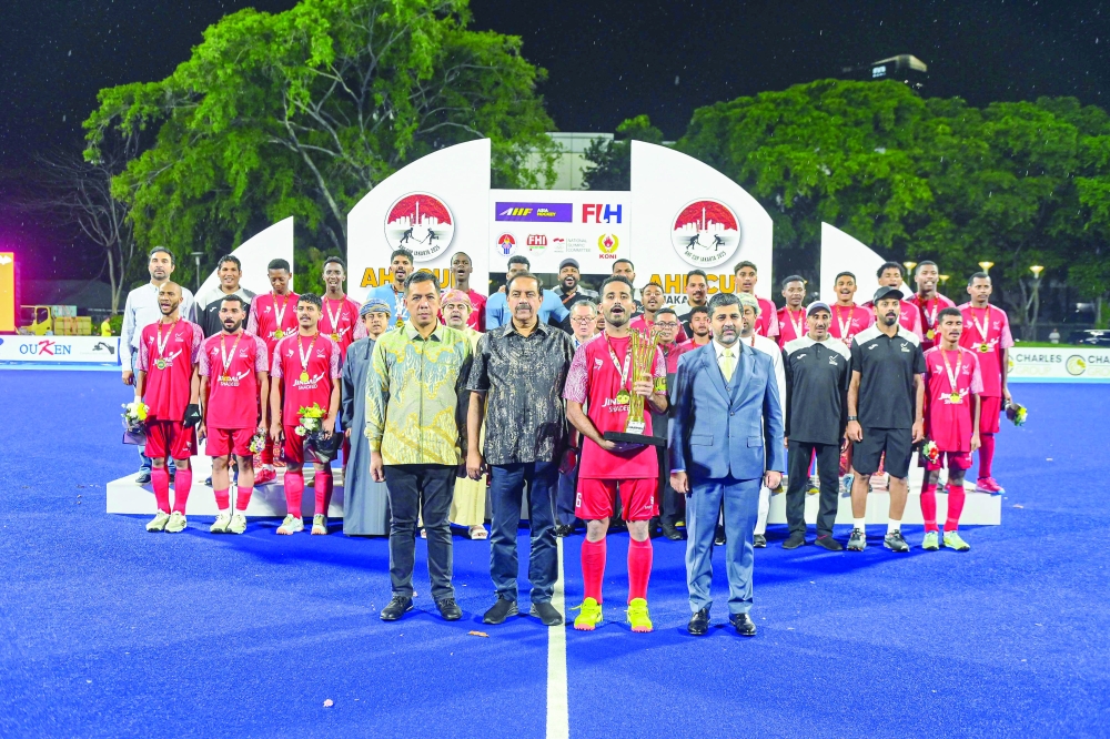 Oman captain receives the trophy.