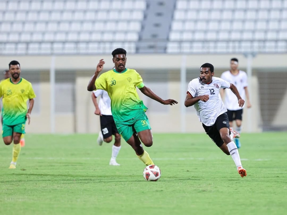 Al Rustaq and Al Khabourah players fight for the ball.