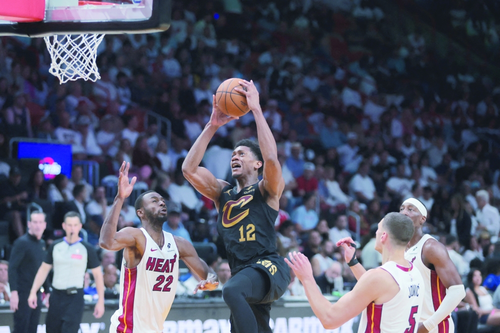 Cleveland Cavaliers forward De'Andre Hunter (12) drives to the basket against Miami Heat forward Andrew Wiggins (22) in the third quarter during game four at Kaseya Center. — Reuters