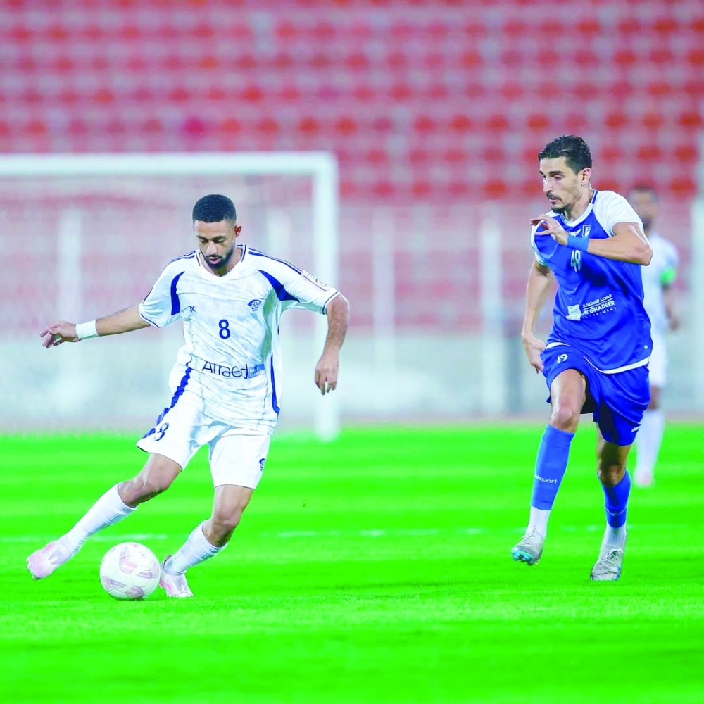 Al Shabab and Saham players fight for the ball.