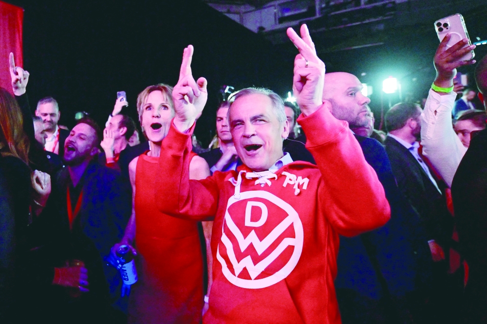 Canada’s Prime Minister Mark Carney dances next to his wife Diana Fox Carney during an event at the Liberal Party election night headquarters in Ottawa, Ontario. — Reuters