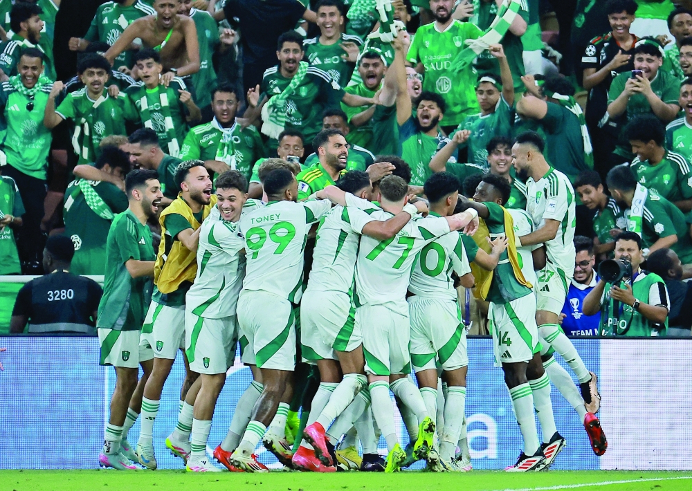 Al Ahli players celebrate their third goal. — Reuters