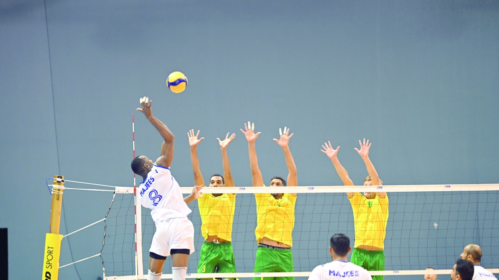 Majees player makes a smash as Seeb players defend. — Abdulwahid al Hamadani
