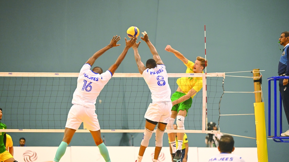 A Seeb player makes a smash as Majees players block. — Abdulwahid al Hamadani