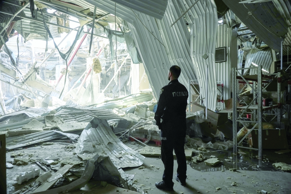 A police officer stands at the site of a building damaged during a Russian drone strike, in Odesa. — Reuters