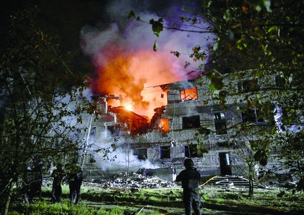 Rescuers work at the site of an apartment building hit by a Russian drone strike, in Zaporizhzhia, Ukraine. — Reuters