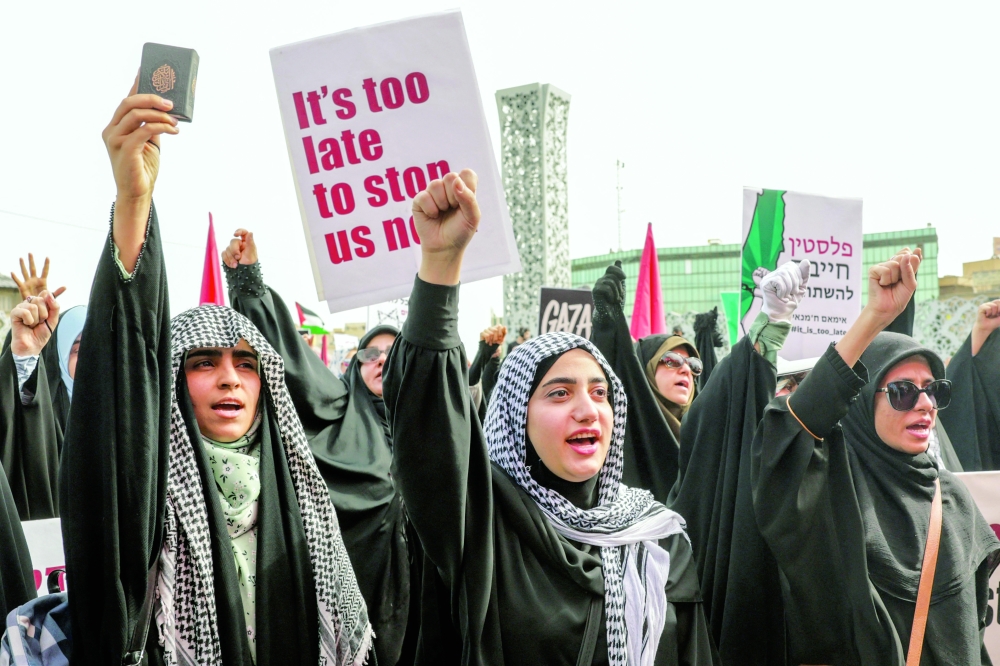 Iranian women shout slogans during a Pro-Palestinian rally in Tehran on Friday. Iran said that continued US sanctions on its trade partners will not alter its policy. — AFP