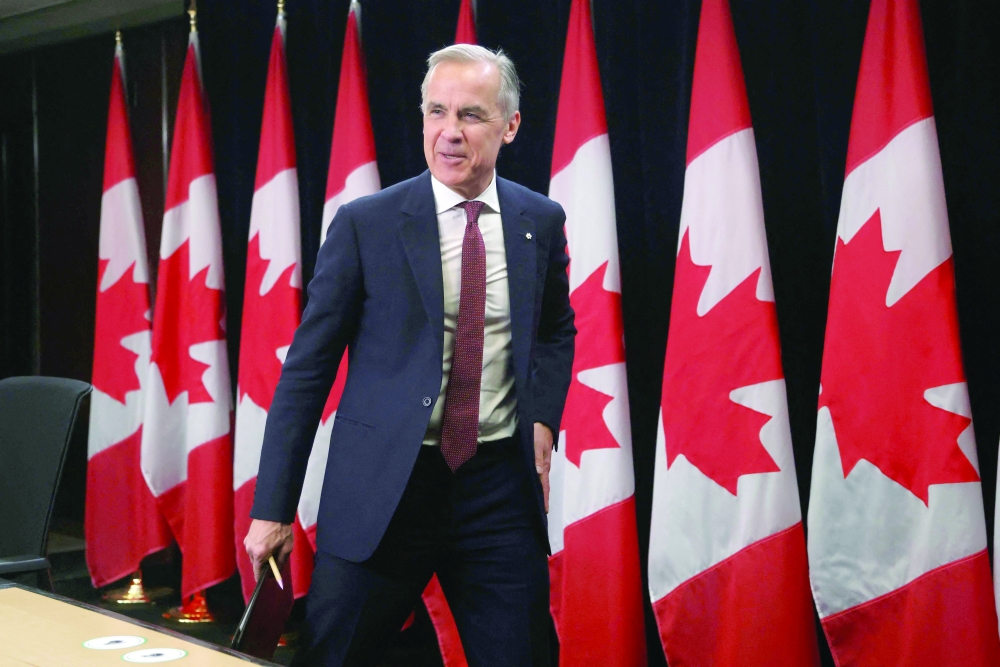 Canada's Prime Minister Mark Carney walks off after a press conference in Ottawa. — AFP