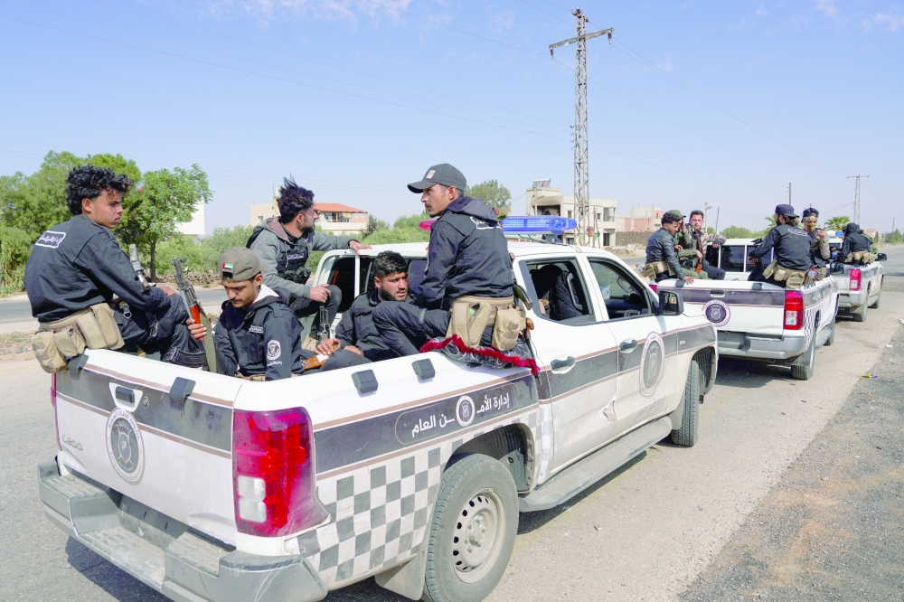 Syrian security forces patrol after being deployed in the village of Al Soura Al Kubra. — Reuters