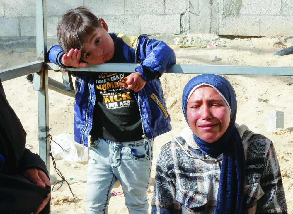 A woman reacts as mourners