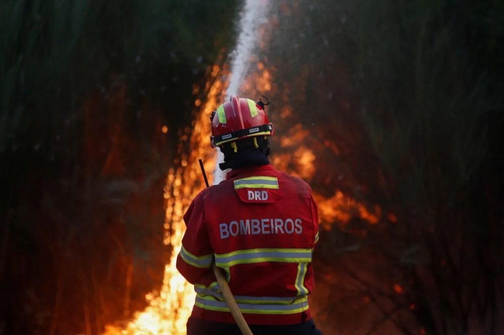 A firefighter handles a wildfire in Videmonte, Celorico da Beira, Portugal. - Reuters file photo