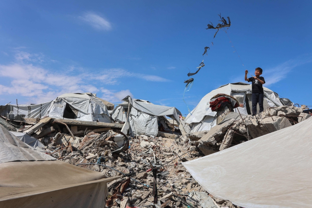 A Palestinian boy flies a kite