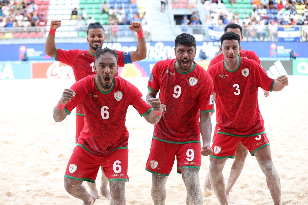 Oman players celebrate after winning the match
