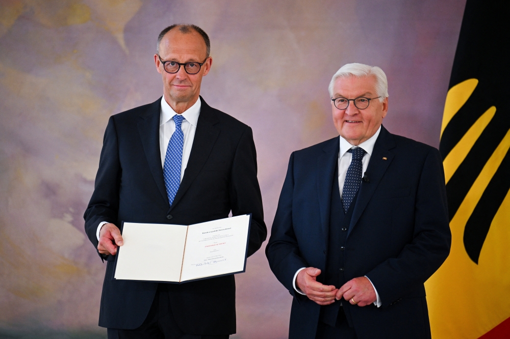 Incoming German Chancellor Friedrich Merz receives his certificate of appointment from German President Frank-Walter Steinmeier during a ceremony at Bellevue Palace in Berlin, Germany May 6, 2025. REUTERS/Annegret Hilse
