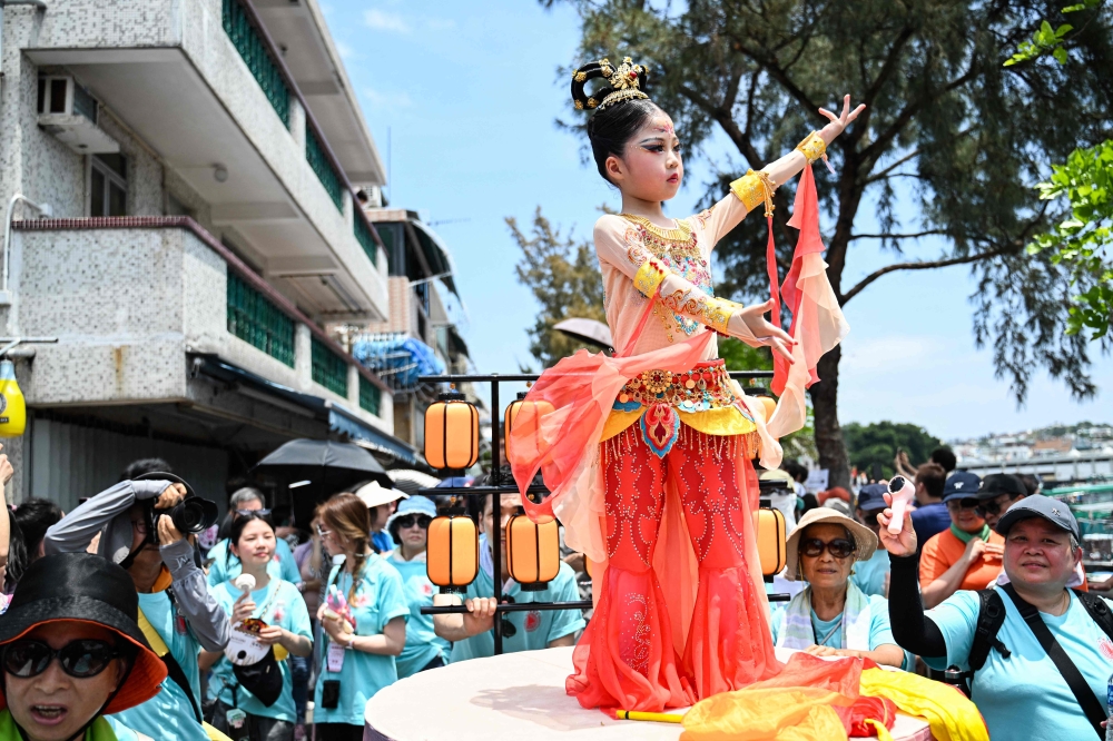 A child participates in the "Piu Sik" parade on the island of Cheung Chau during its annual Bun festival in Hong Kong on May 5, 2025. (Photo by Peter PARKS / AFP)
