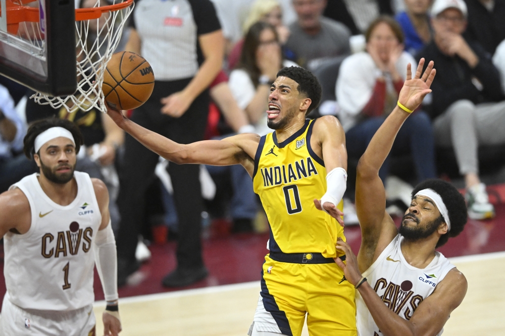 May 6, 2025; Cleveland, Ohio, USA; Indiana Pacers guard Tyrese Haliburton (0) drives to the basket between guard Max Strus (1) and center Jarrett Allen (31) in the fourth quarter during game two of the second round of the 2025 NBA Playoffs at Rocket Arena. Mandatory Credit: David Richard-Imagn Images

