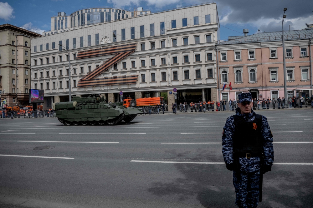 A Russian military vehicle moves along the Garden Ring road in front of a huge Z letter, in central Moscow. — AFP 