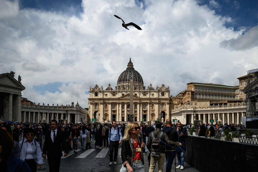 Attendees wait for the start at the conclave, on St Peter's Square, in front of St Peter's Basilica, in The Vatican. — AFP