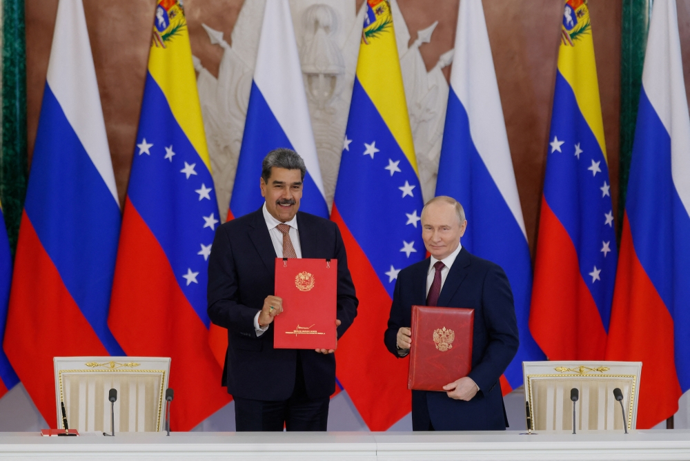 Russian President Vladimir Putin and Venezuelan President Nicolas Maduro pose for a picture during a signing ceremony, in Moscow. — Reuters