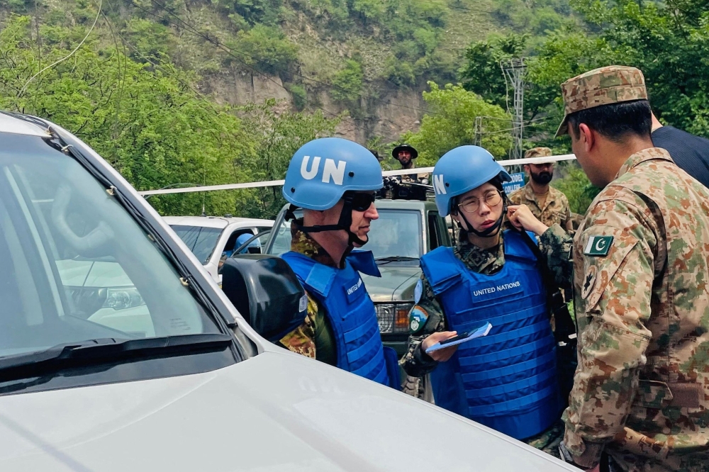 UN military observers arrive to inspect a site after Indian strikes in Muzaffarabad. — AFP