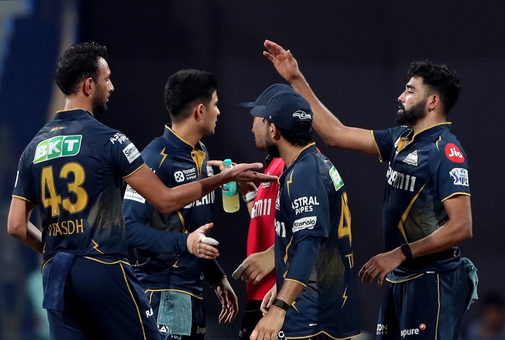 Cricket - Indian Premier League - IPL - Mumbai Indians v Gujarat Titans - Wankhede Stadium, Mumbai, India - May 6, 2025 Gujarat Titans' Prasidh Krishna celebrates with teammates after taking the wicket of Mumbai Indians' Naman Dhir, caught out by Shubman Gill REUTERS/Stringer
