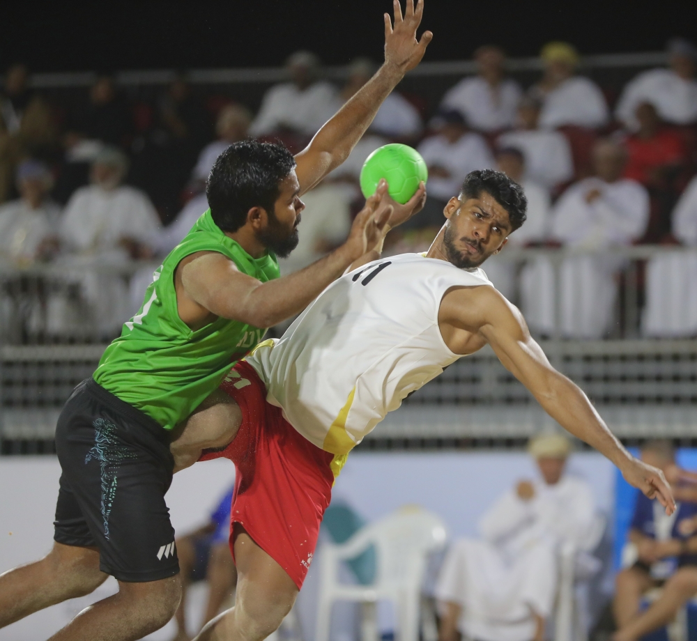 Oman player makes a shot against Maldives.