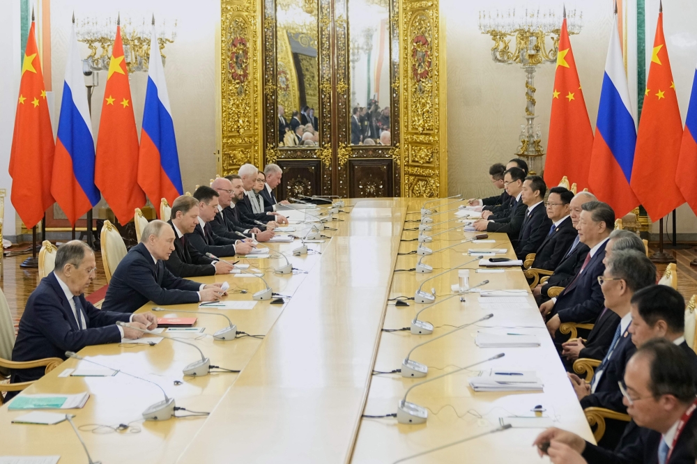 Russian President Vladimir Putin meets with his Chinese counterpart Xi Jinping at the Kremlin in Moscow. — AFP