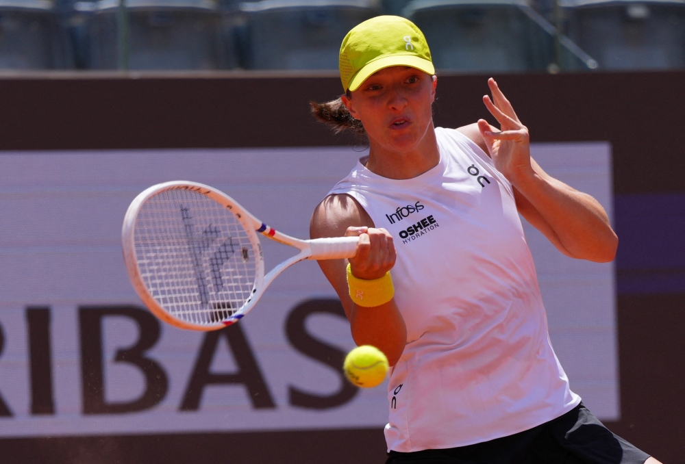 Poland's Iga Swiatek in action during her round of 64 match against Italy's Elisabetta Cocciaretto. — Reuters