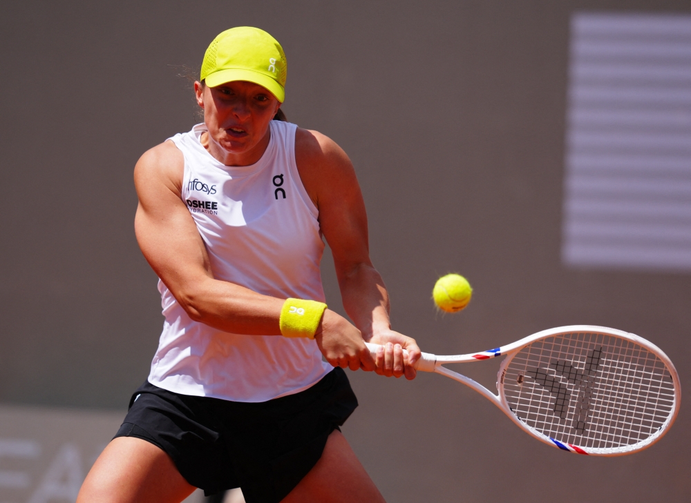 Poland's Iga Swiatek in action during her round of 64 match against Italy's Elisabetta Cocciaretto. — Reuters