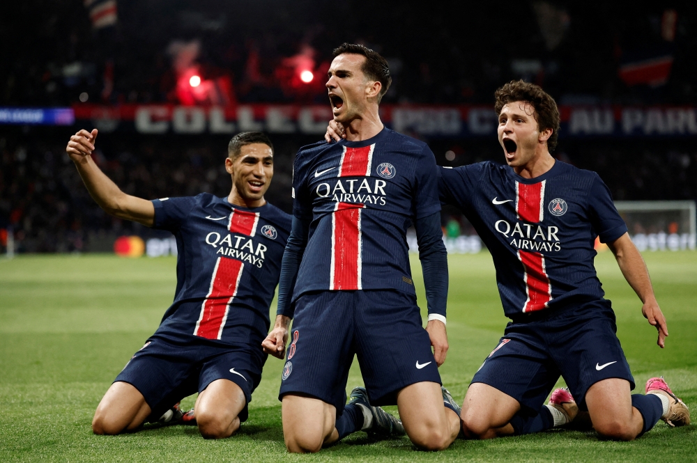 Soccer Football - Champions League - Semi Final - Second Leg - Paris St Germain v Arsenal - Parc des Princes, Paris, France - May 7, 2025 Paris St Germain's Fabian Ruiz celebrates scoring their first goal with Achraf Hakimi and Joao Neves REUTERS/Benoit Tessier     TPX IMAGES OF THE DAY