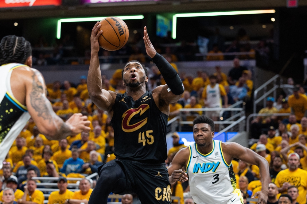 May 9, 2025; Indianapolis, Indiana, USA; Cleveland Cavaliers guard Donovan Mitchell (45) shoots the ball while Indiana Pacers forward Obi Toppin (1) defends during game three of the second round for the 2025 NBA Playoffs at Gainbridge Fieldhouse. Mandatory Credit: Trevor Ruszkowski-Imagn Images
