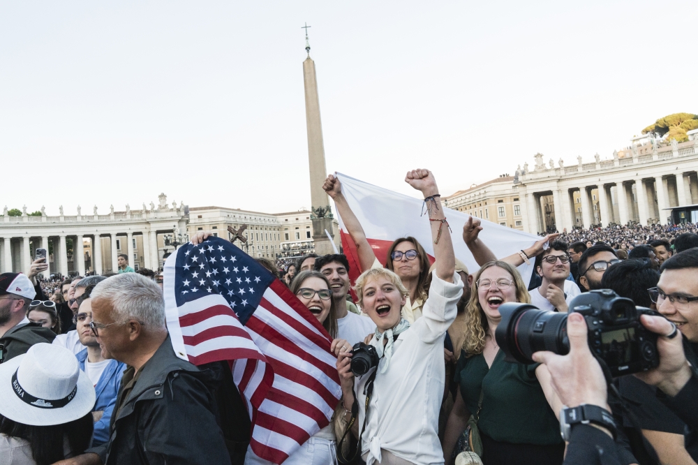 Americans cheer the announcement of Cardinal Robert Francis Prevost as the new pope in Vatican City on Thursday, May 8, 2025. Other spectators were bewildered when his identity emerged. (Gianni Cipriani/The New York Times) 