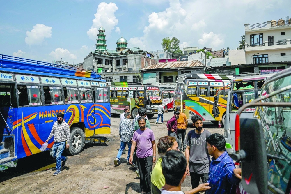 People gather at a bus station in the main town of Poonch district in Jammu region. — AFP