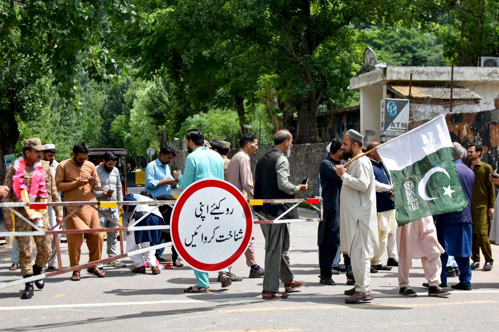 People gather at a border post in the frontier village of Chakothi near the Line of Control (LoC), in Pakistan-administered Kashmir on May 11, 2025.