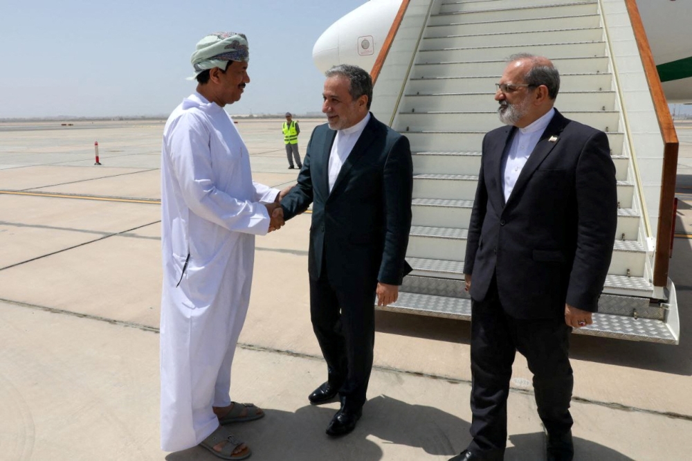 Iran's Foreign Minister Abbas Araghchi is welcomed upon his arrival in Muscat