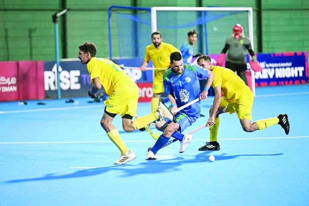 Ahli Sidab and Seeb players fight for the ball.