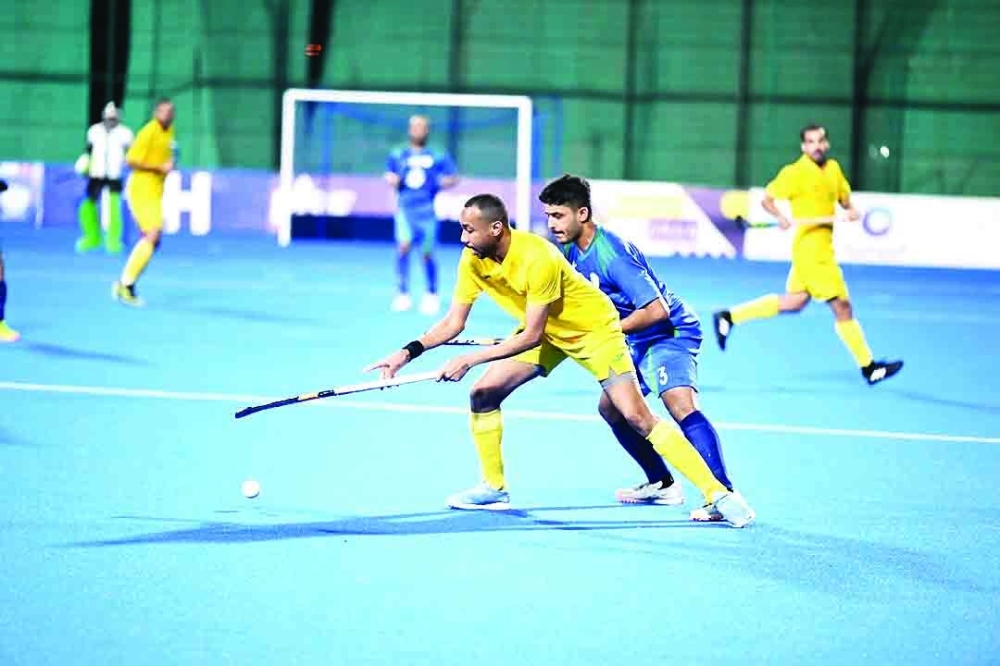 Ahli Sidab and Seeb players fight for the ball.