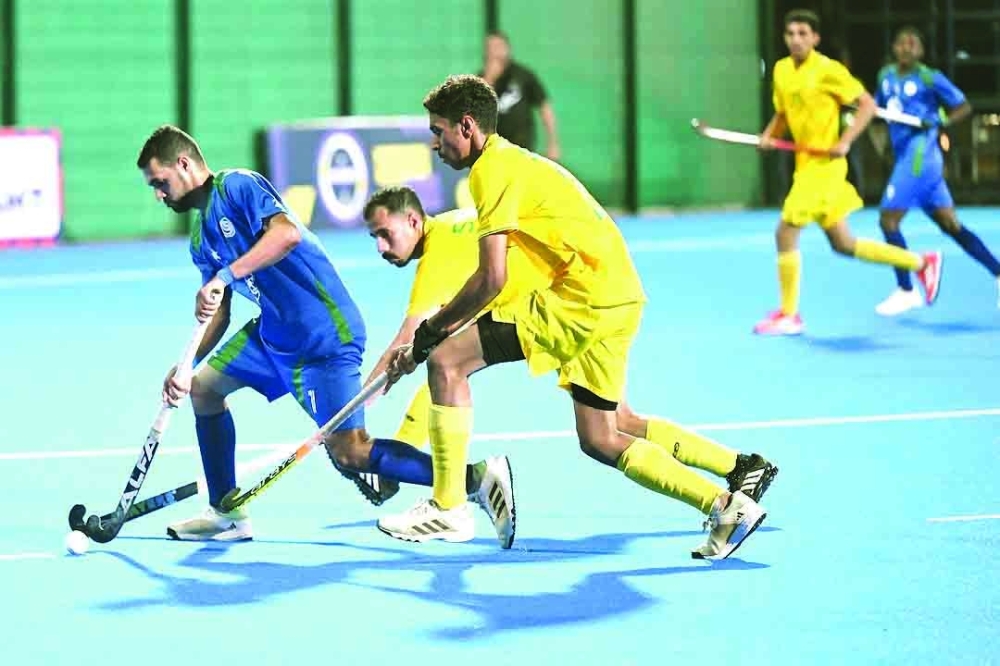 Ahli Sidab and Seeb players fight for the ball.