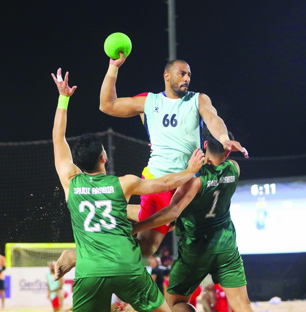 Oman player attempts a shot at Saudi goal.