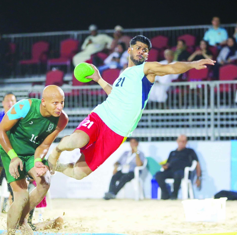 Oman player attempts a shot at Saudi goal.