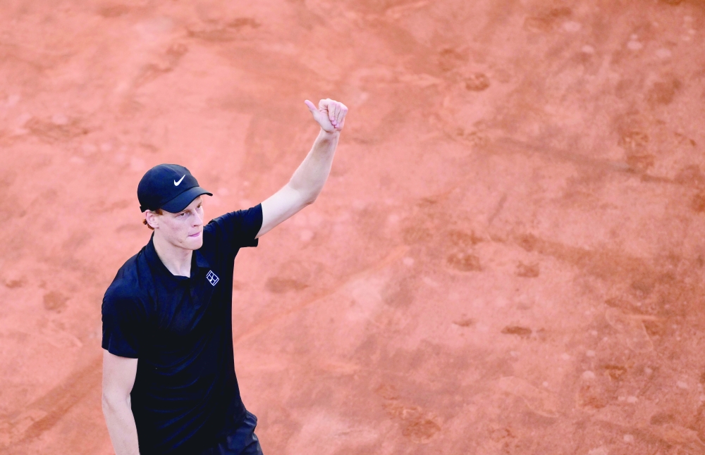 Italy's Jannik Sinner celebrates winning against Netherland Jesper De Jong at the end of their round of 16 men's singles match of the WTA Rome Open tennis tournament at Foro Italico in Rome on May 12, 2025. (Photo by Marco BERTORELLO / AFP)

