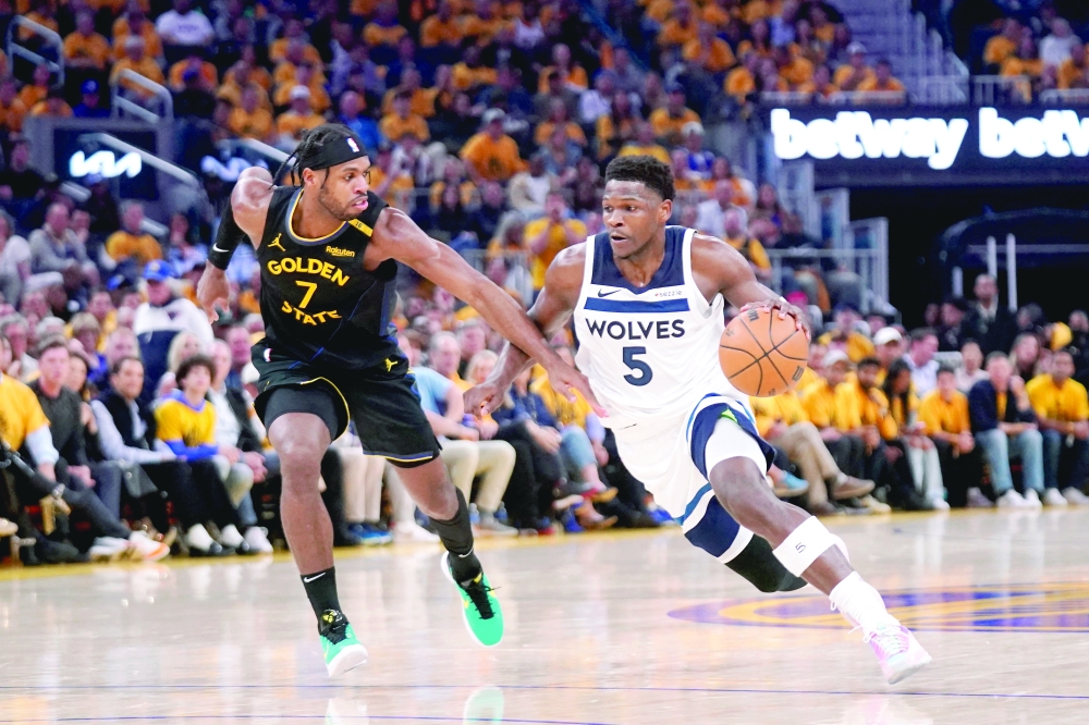 Minnesota Timberwolves guard Anthony Edwards (5) dribbles the ball next to Golden State Warriors guard Buddy Hield (7) in the first quarter during game four of the second round for the 2025 NBA Playoffs at Chase Center. — Reuters