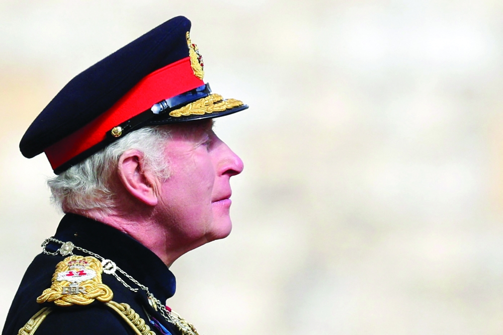 Britain's King Charles III reacts as he attends a ceremony to present the new standards and colours to regiment members of the Life Guards and the Blues and Royals at Windsor Castle, on Monday. — AFP