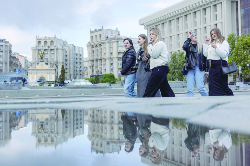 Women walk in Maidan Nezalezhnosti or Independence Square, amid Russia's attack on Ukraine, in Kyiv, on Tuesday. — Reuters