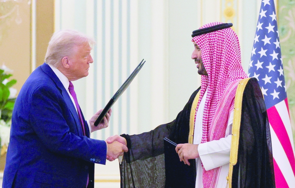 US President Donald Trump and Saudi Crown Prince and Prime Minister Mohammed Bin Salman shake hands during a Memorandum of Understanding (MOU) signing ceremony at the Royal Court in Riyadh, Saudi Arabia, on Tuesday. — Reuters