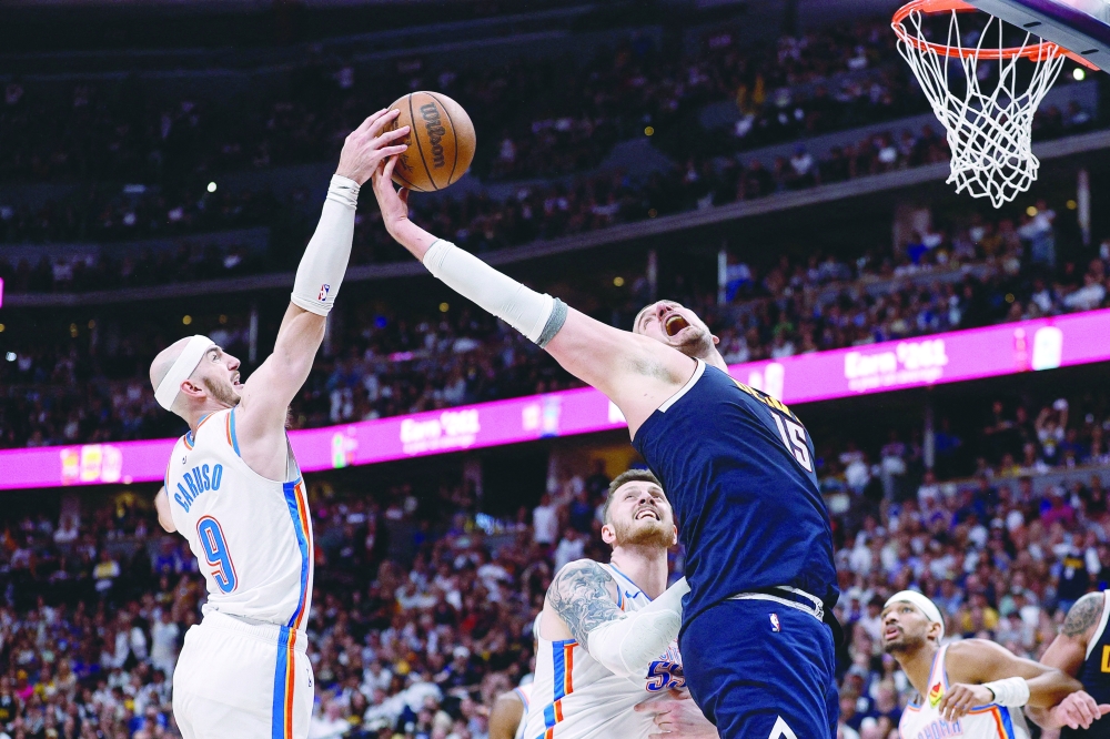 Oklahoma City Thunder guard Alex Caruso (9) and Denver Nuggets centre Nikola Jokic (15) battle for a rebound as centre Isaiah Hartenstein (55) defends in the fourth quarter during game four of the second round of the 2025 NBA Playoffs at Ball Arena. — Reuters