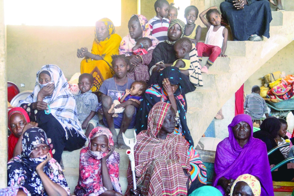 Displaced Sudanese sit at a shelter after they were evacuated, in Omdurman. — AFP